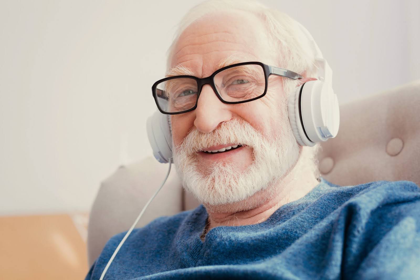 Senior man listening on headphones