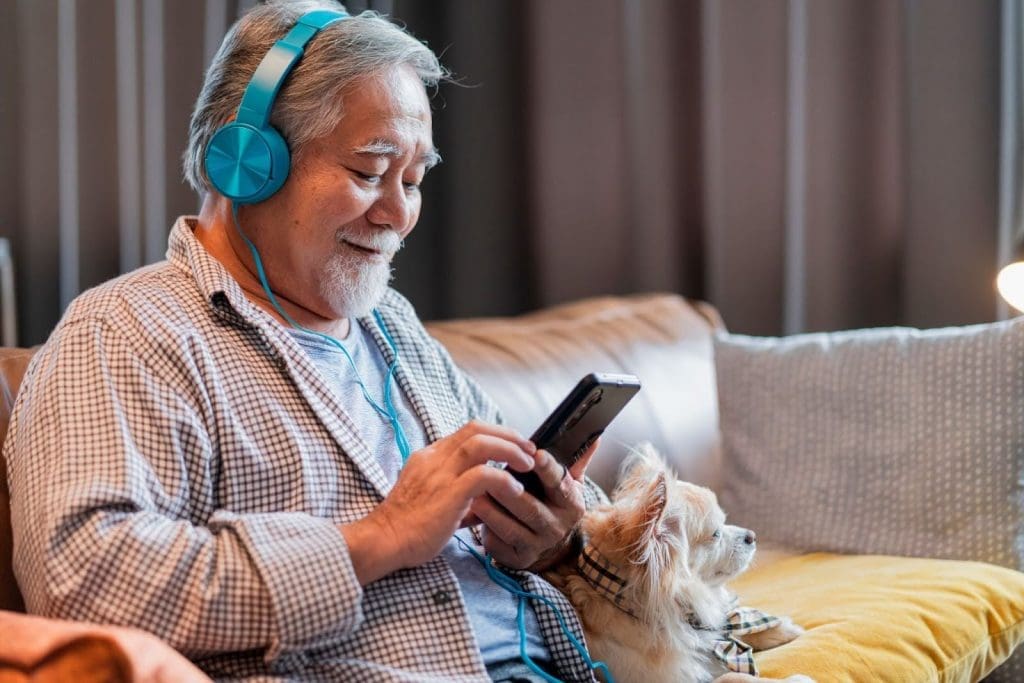 Senior man listening to a podcast from his phone